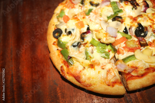 pizza with ham and mushrooms on wooden table