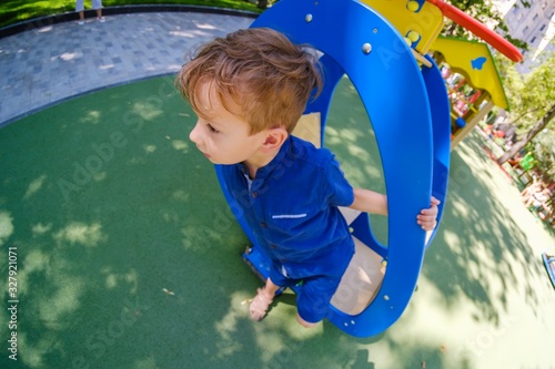 Happy boy on playground, su...