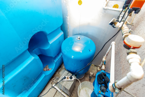 water tanks and pumps for water supply in the basement of the cottage