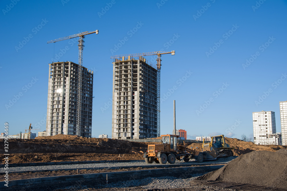 Сonstruction machine Motor Grader and bulldozer at a construction site level the ground and gravel stones for the construction of a new asphalt road. Road construction equipment. Сonstruction machine Motor Grader and bulldozer at a construction site level the ground and gravel stones for the construction of a new asphalt road. Road construction equipment.