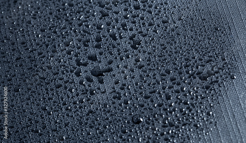 macro grey nylon with water drops, nylon fabric textured background closeup photo