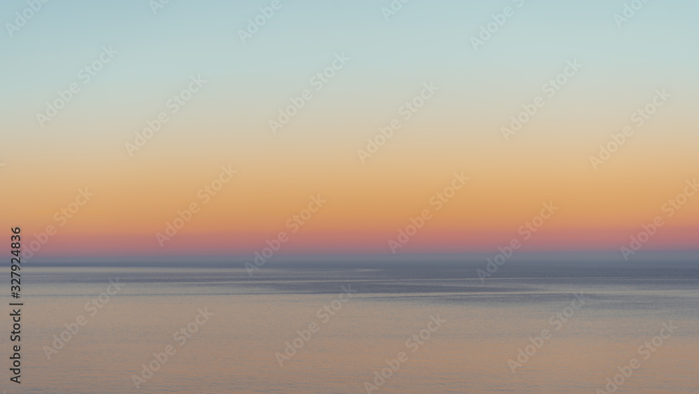 Abstract background of a sea horizon with a degradation of red, orange and blue colors of a sunset Abstract background of a sea horizon with a degradation of red, orange and blue colors of a sunset
