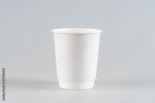 Disposable, cardboard white Cup isolated on a white background.