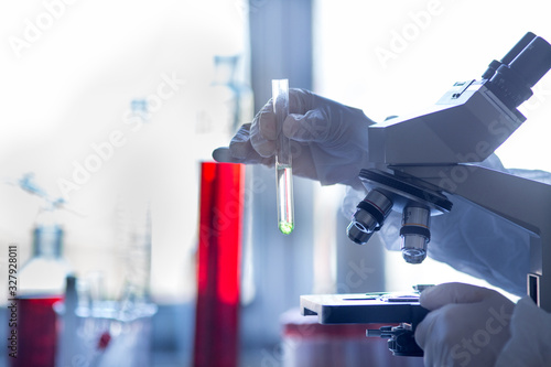 Biologist working on microscope in laboratory