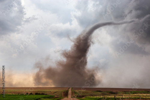 A dusty tornado crosses a dirt road during a severe weather outbreak near McCook, Nebraska