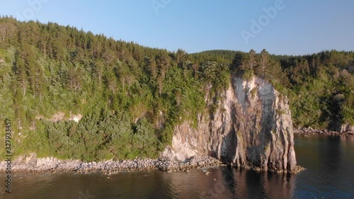 Aerial: Fly-over of a beautiful rocky coastline, New Zealand photo