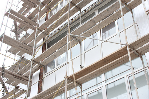 Scaffolding installed to repair and warm the walls of the house