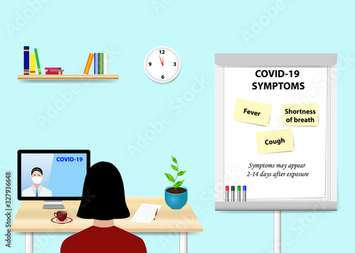 Woman is educating in COVID-19 disease a doctor communicating with her from a PC standing on the table. Description of symptoms is written on the flipchart standing next to her.