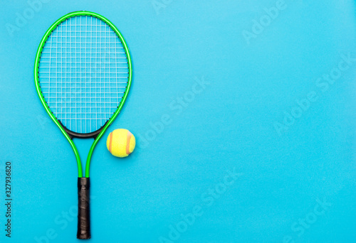 Top view of tennis rackets and ball on blue background. © Augustas Cetkauskas