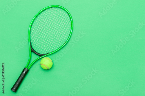 Top view of tennis racket and ball of green background. © Augustas Cetkauskas