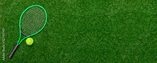 Top view of tennis racket and ball of green grass. Horizontal sport poster, greeting cards, headers, website © Augustas Cetkauskas