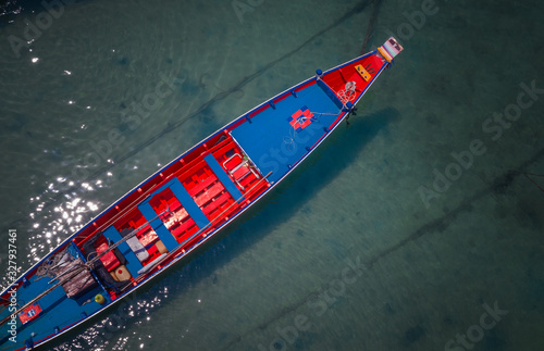 Top view of beautiful clear sea water with colorful long tail boats in the summer of tropical island named Koh Tao in Surat thani, Thailand. © chanchai