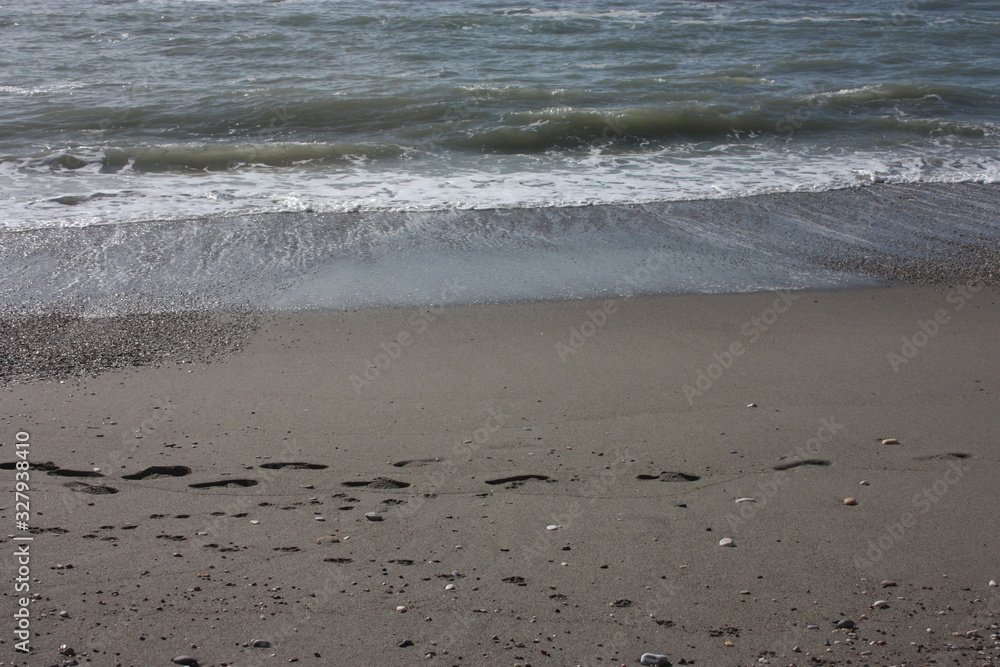 A winter beach with rough seas with cold and dull colors in the Versilian Riviera A winter beach with rough seas with cold and dull colors in the Versilian Riviera