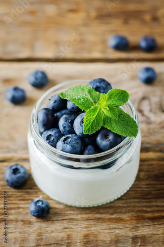 Greek yogurt blueberry parfaits with fresh berries and mint leaves
