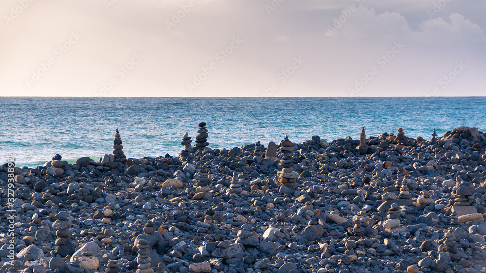 Stone beach with pebble columns. Panorama beach. Ocean view Stone beach with pebble columns. Panorama beach. Ocean view
