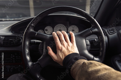 driver clicks on the steering wheel signal while traveling. © velimir