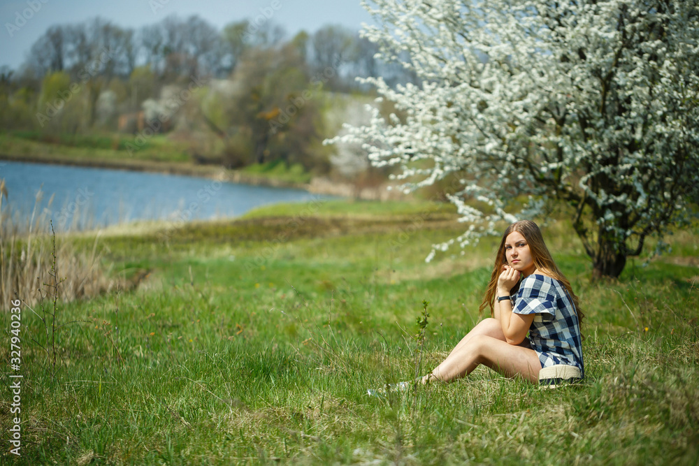 beautiful girl in a dress walking in the spring forest where the trees bloom beautiful girl in a dress walking in the spring forest where the trees bloom
