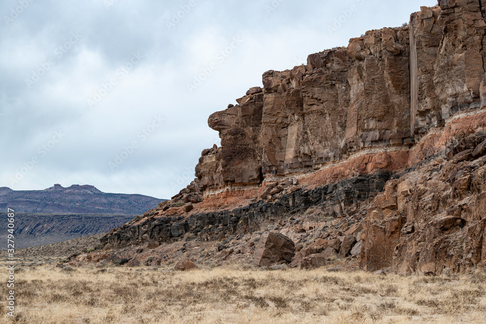 Banded Volcanic Rock Outcroppings cromposed of different colored layers of solidified volcanic flows in White River Narrows, Basin and Range National Monument, Nevada. Banded Volcanic Rock Outcroppings cromposed of different colored layers of solidified volcanic flows in White River Narrows, Basin and Range National Monument, Nevada.