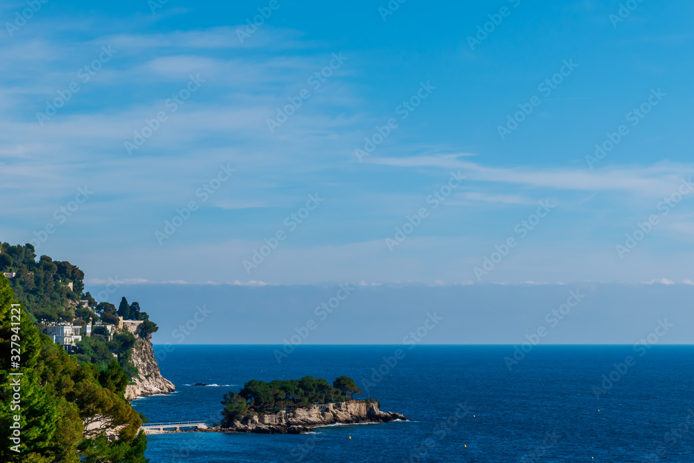 The panoramic view of the landscape of Èze, the Mediterranean Sea's turquoise water and the Alps mountains cliffs (Provence Côte d'Azur, France)
