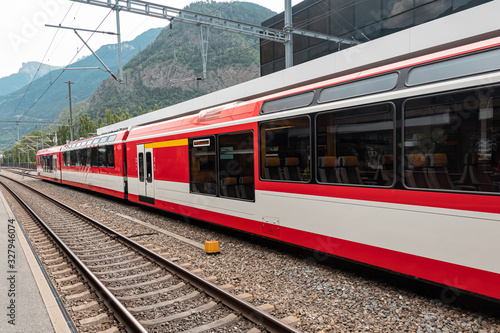 A train of Swiss railways arrived at the station. Trains are one of a tourist attraction in Switzerland.