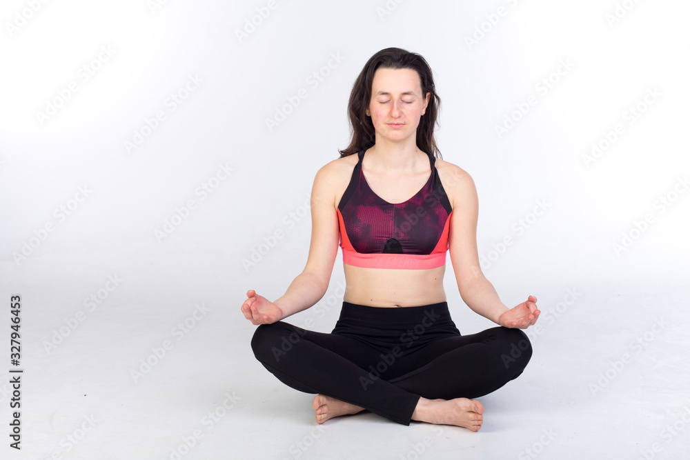 woman in leggings and sports bra is stretching and practicing yoga woman in leggings and sports bra is stretching and practicing yoga