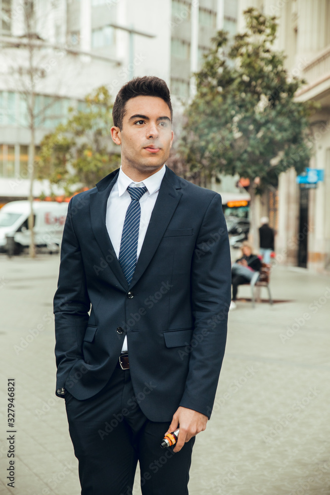 Boy in suit smoking with vaper Boy in suit smoking with vaper