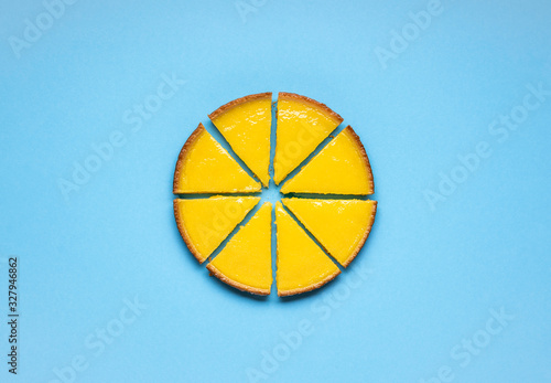 Sliced lemon pie on blue background. Fruit tart slices
