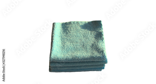 Rags for cleaning folded in a stack on a white background. Blue choppers for cleaning furniture from dust.