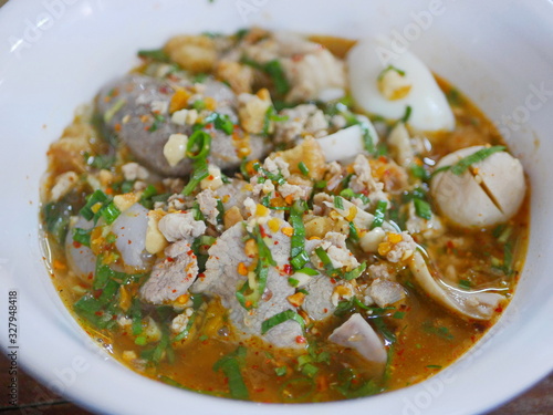 Close up of tasty spicy noodle pork soup ( Guay Tiao Tom Yum Moo ) - delicious and healthy street food in Thailand photo