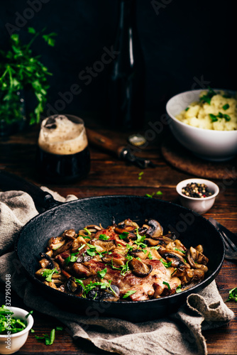 Fried pork neck steak with different mushrooms and mashed potatoes