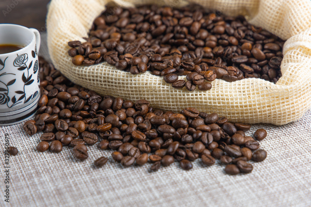 Coffee beans in coffee bag with two white cups and space for text Coffee beans in coffee bag with two white cups and space for text