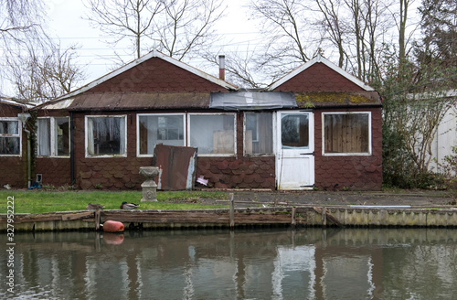 Old decrepit canal side shack image © simonXT2