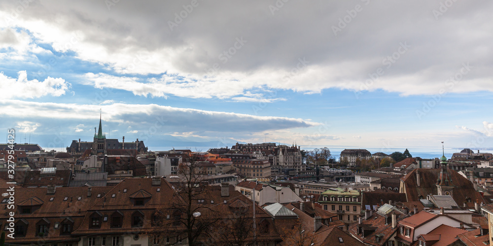 Stunning aerial panorama view of Lausanne downtown cityscape with Lake Geneva (Leman) in background from Cathedral of Notre Dame on  cloudy autumn day with blue sky cloud, Canton of Vaud, Switzerland