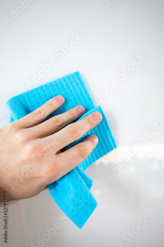 hand cleaning with blue sponge isolated on white background. Spring Cleaning Theme