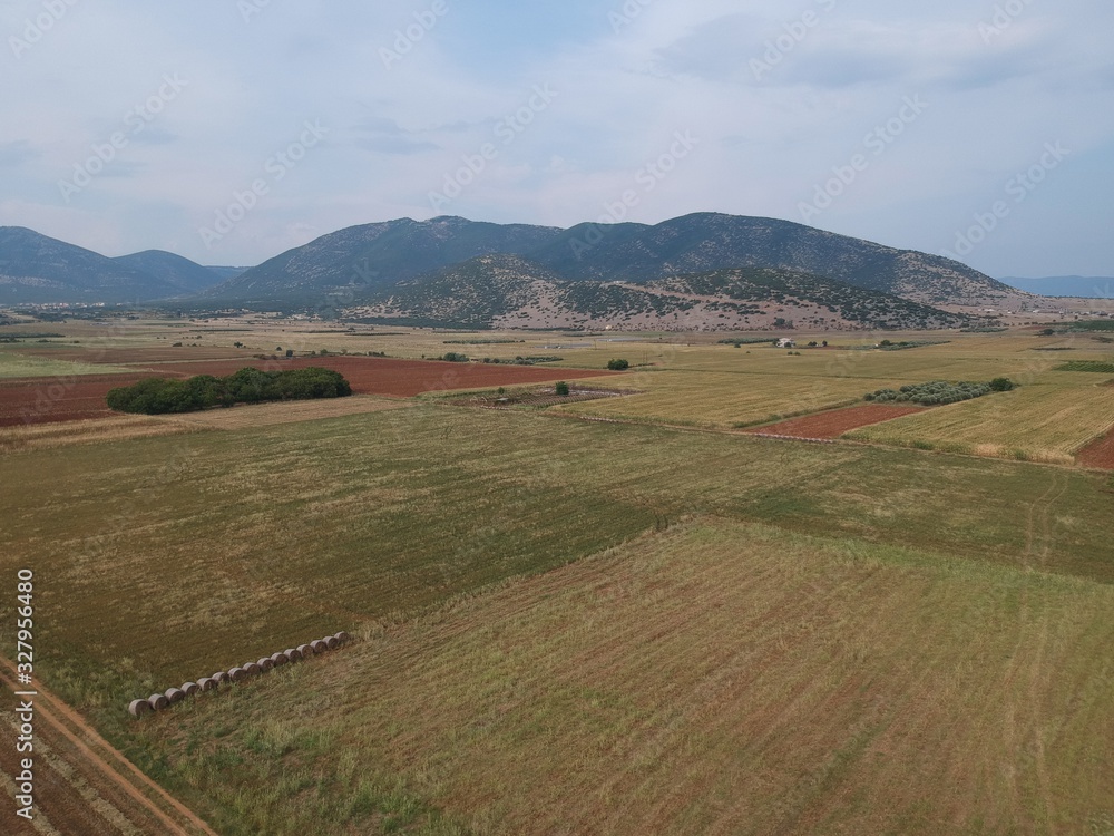 Aerial drone landscape photo from high above of fields in a clear weather summer day  in the outskirts of Drama, Greece