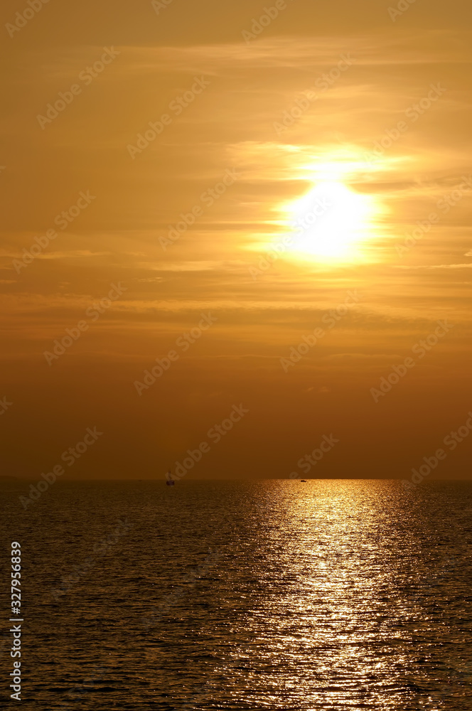 A beautiful sunset at sea in orange tones with seagulls and a sea vessel. Russia's Black Sea coast