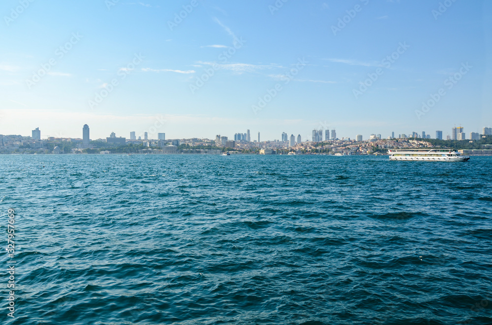 Ships going on sea. Istanbul cityscape from the Bosphorus during warm summer day. Travel to Turkey and a sea cruise around the city. Panorama of the city from the sea.