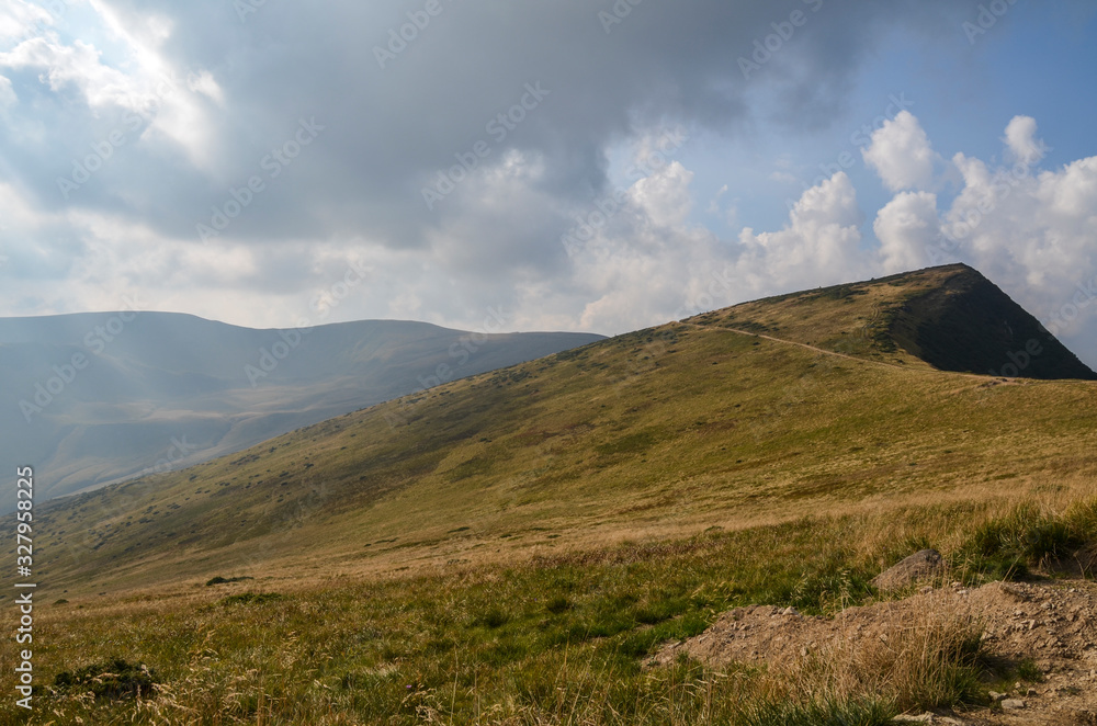 Obraz premium Steep hillsides of Mountain ranges and treking road on Svydovets ridge. Lovely summer scenery of Carpathian mountains. Wonderful nature background 