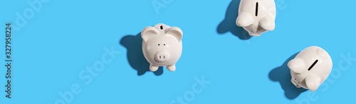 White piggy banks overhead view - flat lay