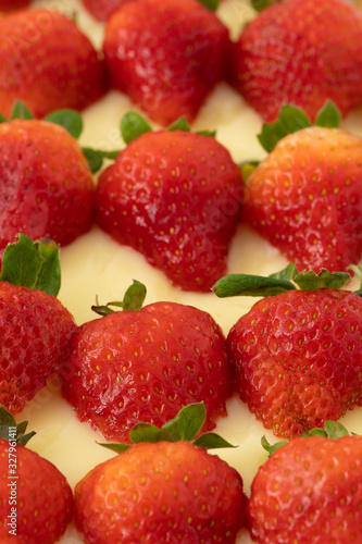 Fototapeta Naklejka Na Ścianę i Meble -  Strawberry tart with fresh red strawberries and a cream custard. A close up macro photography shot.
