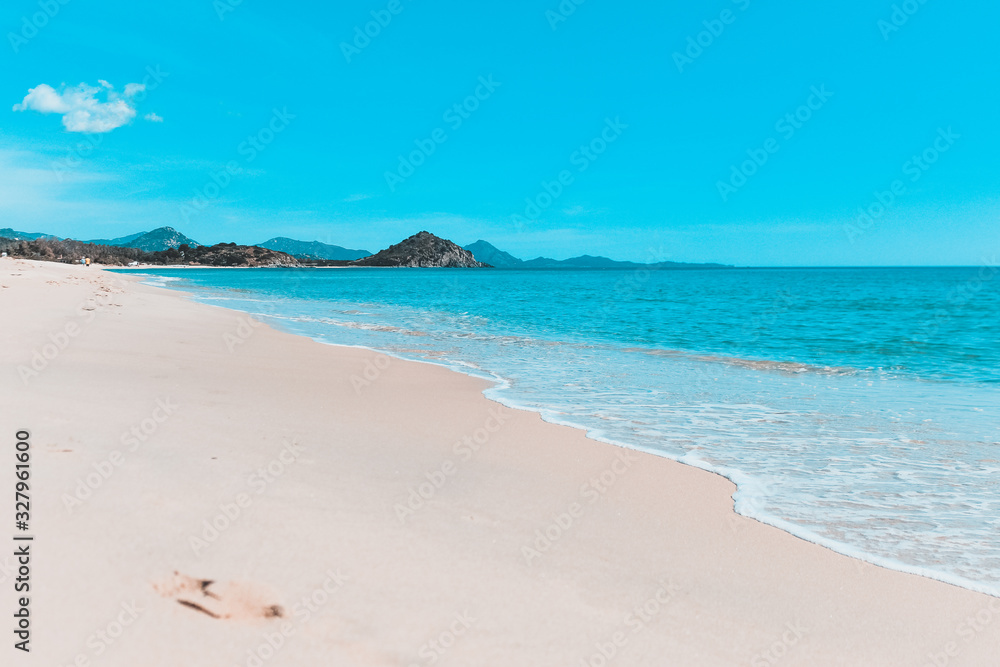 Daylight landscape of Porto Giunco's beach, soft waves, beach and clouds Daylight landscape of Porto Giunco's beach, soft waves, beach and clouds
