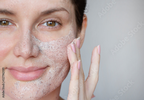  young woman does face peeling from black dots photo