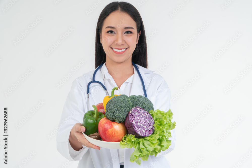 Doctor or nutritionist holding fresh fruit (Orange, red and green apples) and smile in clinic. Healthy diet Concept of nutrition food as a prescription for good health, fruit is medicine Doctor or nutritionist holding fresh fruit (Orange, red and green apples) and smile in clinic. Healthy diet Concept of nutrition food as a prescription for good health, fruit is medicine
