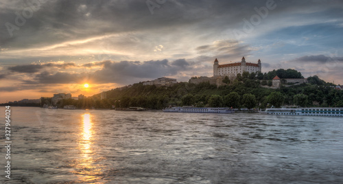 Colorful Sunset in the Flooded City with the Castle on the Hill and Ships on the River
