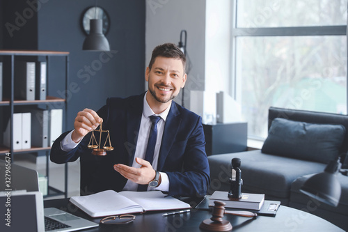 Male lawyer with scales sit...