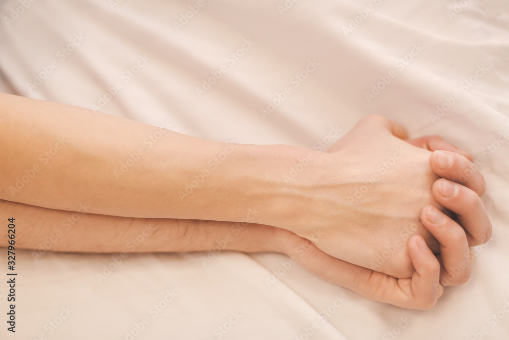 Hands of young couple sleeping in bed Hands of young couple sleeping in bed