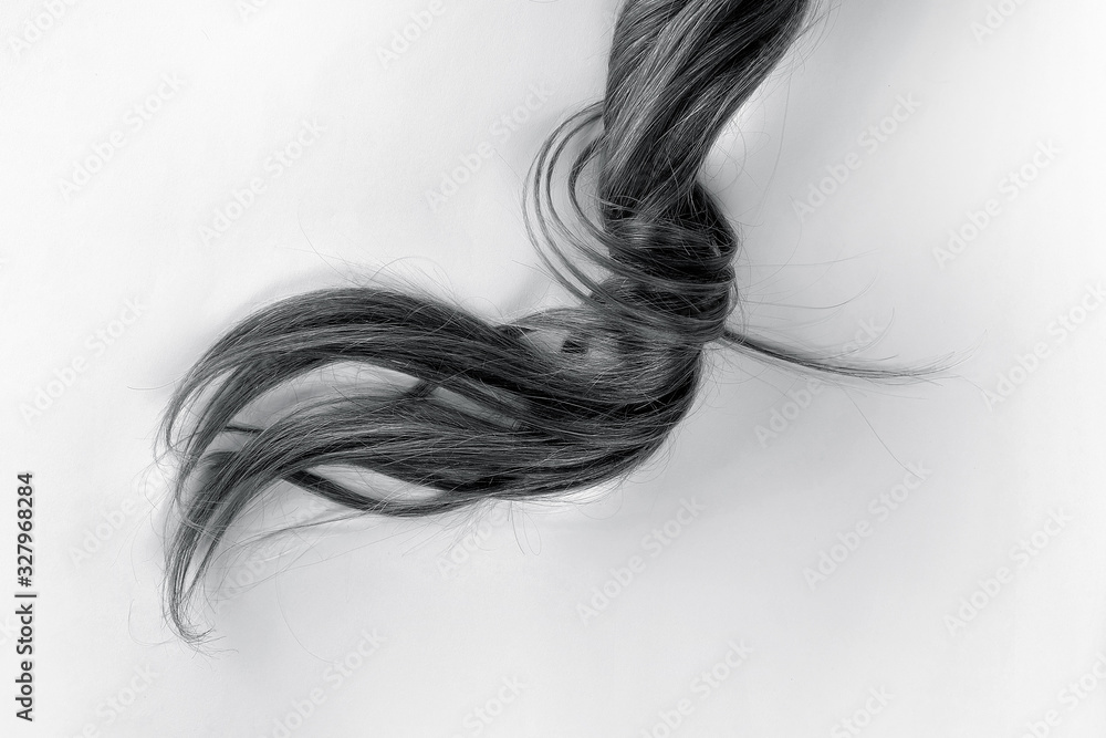 Swirled black hair on white. Disheveled tail Swirled black hair on white. Disheveled tail