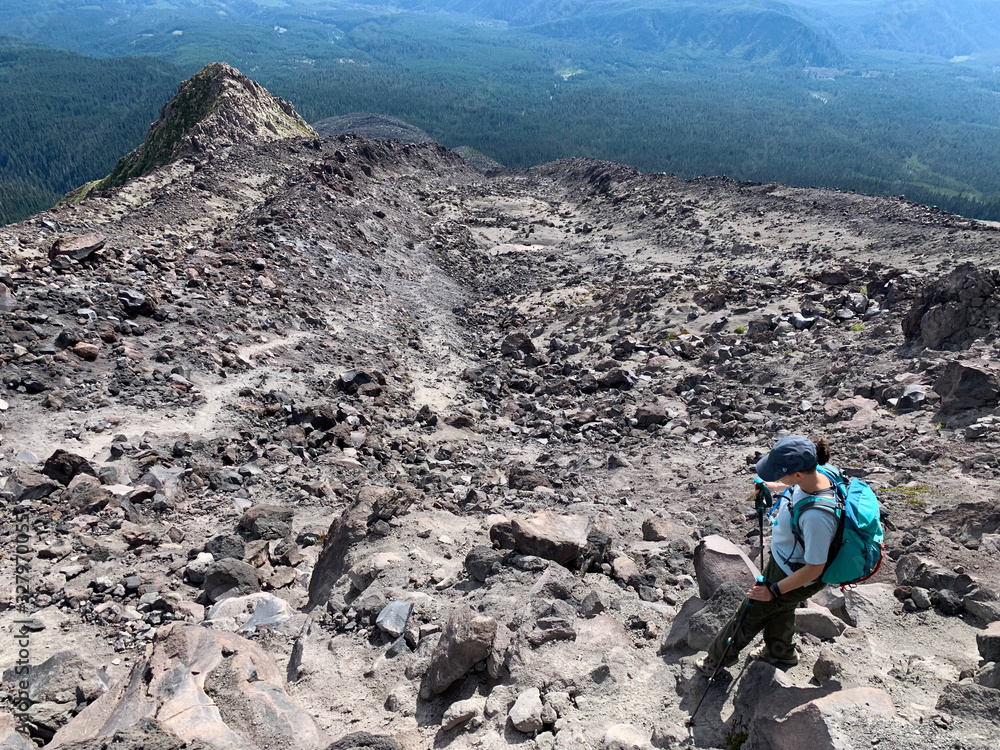 determined woman hiking down a boulder field on Mount Saint Helens