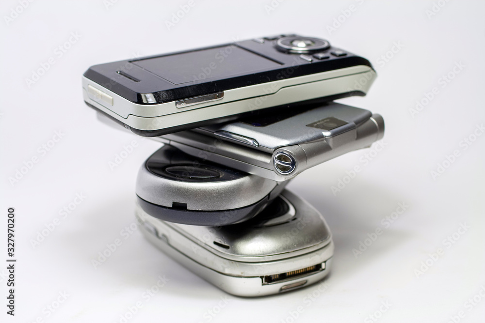 Stacked old mobile phones on white background Stacked old mobile phones on white background