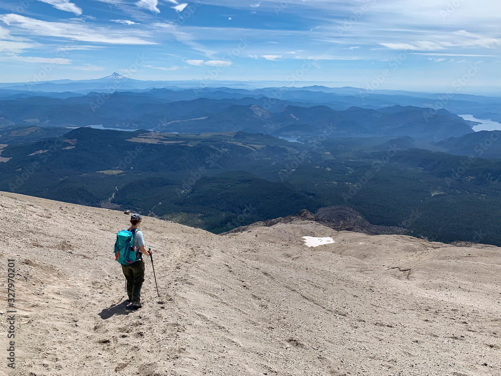 determined woman hiking downhill on Mount Saint Helens
